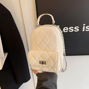 Chic quilted beige mini backpack with chain strap and silver lock shown on elegant background