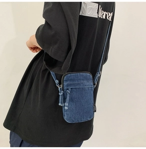 Detail der dunkelblauen Denim Mini Umhängetasche mit Reißverschluss und Schultergurt