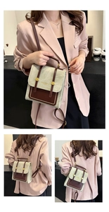 Detailed view of vintage canvas backpack with leather straps and metal magnetic buckles