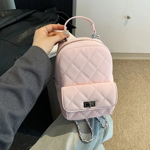 Pink quilted mini backpack with rhombus stitching pattern and metal chain straps
