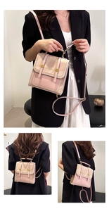 Detail of minimalist pastel handbag showing convertible backpack straps and gold buckle clasp