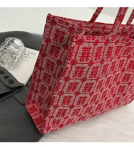 Detail of red woven tote bag featuring traditional Chinese wedding Double Happiness pattern