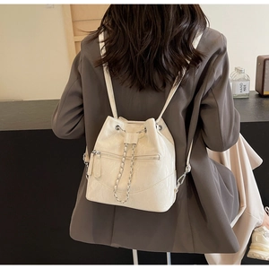 Detail view of off-white glossy leather bucket backpack with silver chain drawstring