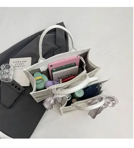 Detail of off-white tote bag interior showing large capacity for daily essentials