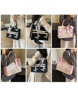 Detail view of large embroidered tote bags with floral patterns and silk scarf decor