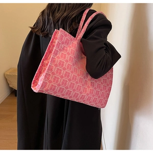 Detail of pink canvas tote bag with red traditional double happiness pattern on shoulder
