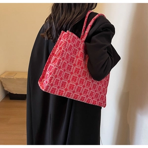 Detail of red bridal tote bag with double handles and traditional Xi pattern embroidery