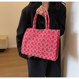 Detail of red jacquard tote bag with traditional Double Happiness pattern and knit texture