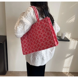 Detail of red wedding tote bag featuring white traditional double happiness jacquard pattern