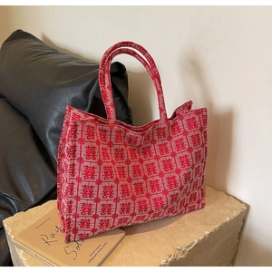 Close-up of red festive bridal tote bag with traditional Xi character woven pattern