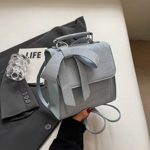 Fashionable light blue backpack with bow decoration and pleated texture for women