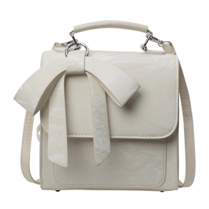 Chic cream crossbody bag with large 3D bow and textured finish for stylish commuting