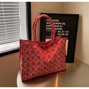Detailed view of red canvas wedding tote bag with traditional white Double Happiness pattern