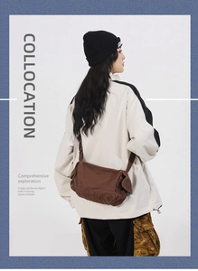 Brown canvas messenger bag detail showing adjustable strap and retro utility style