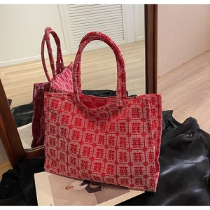 Close-up of red and beige jacquard woven tote bag with Chinese Double Happiness motifs