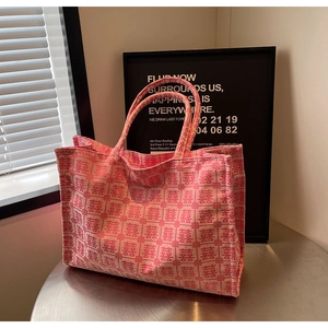 Detail of pink bridal tote bag with red Double Happiness embroidery on fabric