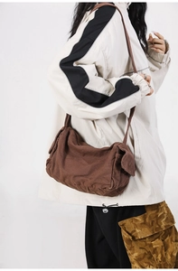 Close-up of vintage brown washed canvas crossbody bag showing side pocket detail