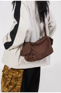 Brown washed canvas crossbody bag with wide shoulder strap in minimalist cargo style