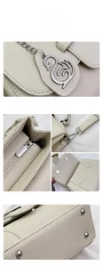 Detail view of lychee pattern leather bag with swan metal charm and dual magnetic buckles