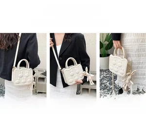 Creamy white mini bag with rabbit relief showing crossbody, shoulder and handheld styles