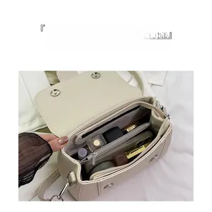 Detail view of large capacity interior with organized compartments for makeup and phone