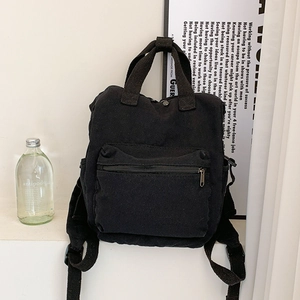 Minimalist black canvas backpack with large capacity for travel and casual daily use