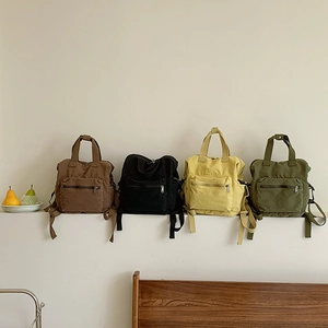 Minimalist canvas backpack in four colors with large capacity for travel and daily use