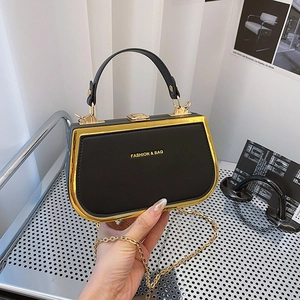 Chic black leather handbag with gold metal trim and chain strap for women