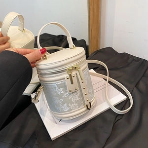 Elegant white floral embroidered bucket bag with gold hardware and top handle strap