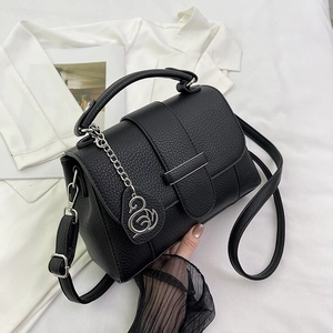 Fashionable black lychee grain faux leather handbag with silver chain and swan charm