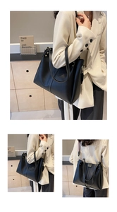 Détails du sac cabas noir avec surpiqûres contrastées et bandoulière géométrique
