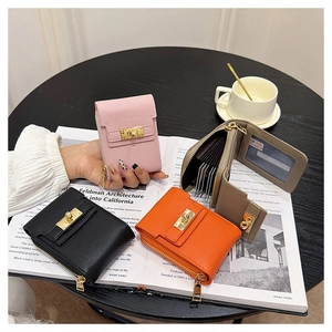 Flat lay of mini accordion card holders with lychee texture and golden twist locks