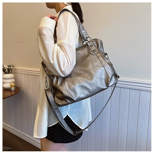 Detail of soft metallic PU leather tote bag with round rivets and adjustable strap