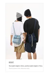Detail of denim drawstring bucket bag showing washed texture and white cotton rope
