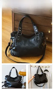 Detail of black faux leather tote bag with silver rivets and detachable shoulder strap