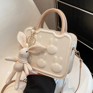 Elegant cream women's crossbody bag with rabbit embossment and woven bunny charm