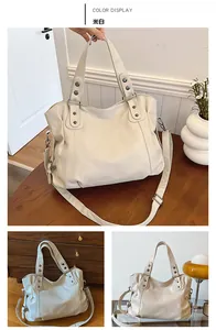 Detail of off-white tote bag with litchi texture PU leather and metal rivet accents