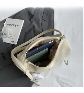 Detail view of large interior capacity of beige canvas tote bag with a tablet inside