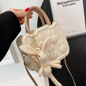 Chic cream white crossbody bag with 3D bunny embossment and cute knitted rabbit charm
