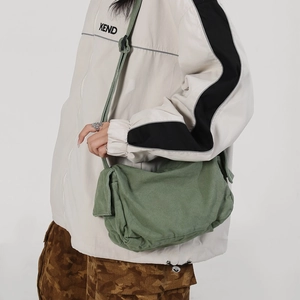 Army green canvas messenger bag with adjustable strap and vintage flap design