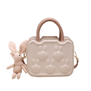 Elegant white square handbag with rabbit motifs and a pink knitted bunny pendant