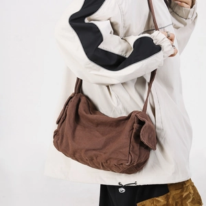 Brown canvas messenger bag for women with side flap pockets and long crossbody strap