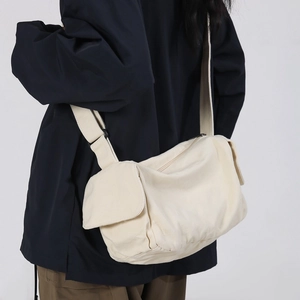 Minimalist beige canvas crossbody bag with adjustable wide strap for casual wear