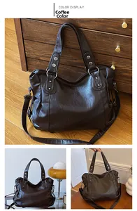Detail of coffee brown large tote bag with vintage soft leather texture and silver rivets