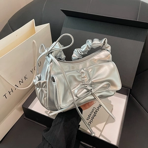 Silver metallic pleated handbag with large bow accent and ruffled handle in a gift box