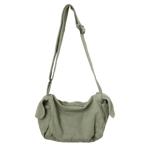 Army green washed canvas crossbody bag with adjustable strap and side pockets