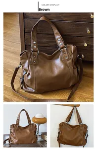 Detail view of large brown faux leather tote bag with vintage silver rivets and detachable strap