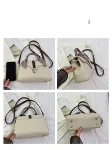 Detail view of cream leather tote with silk scarf handle and silver twist lock mechanism