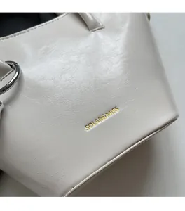 Detail of soft cream leather crossbody bag with solar & miss logo and metal hardware