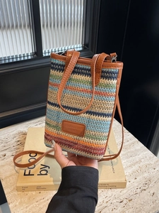 Petit sac seau en paille tissée à rayures colorées avec bandoulière en cuir brun